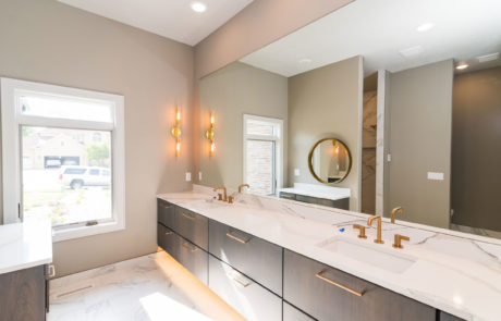 Modern bathroom with double sink, long & wide mirror, & window